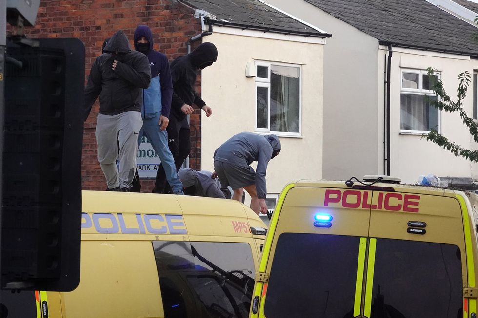 \u200bRiot police hold back protesters