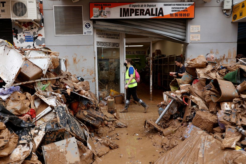 \u200bRubbish and mud piled high outside shop in Valencia