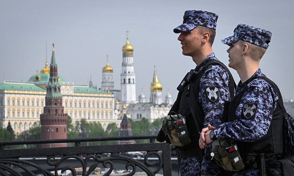 \u200bRussian National Guard (Rosgvardia) servicemen patrol a bridge along the Moskva river in front of the Kremlin