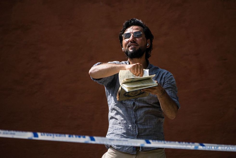 \u200bSalwan Momika destroys a copy of the Koran outside a mosque in Stockholm
