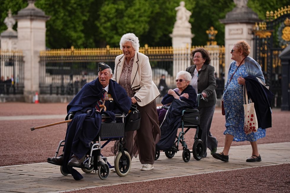 \u200bSecond World War veterans are escorted into Buckingham Palace following the military procession