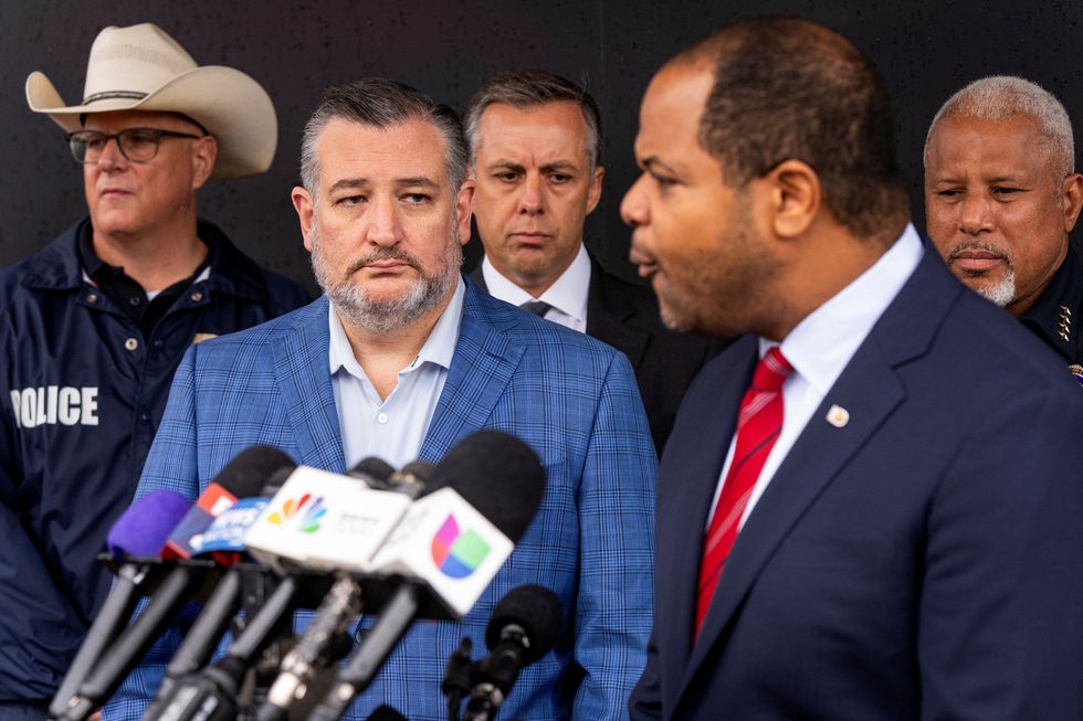 \u200bSenator Ted Cruz listens as Dallas Mayor Eric Johnson speaks at a press conference