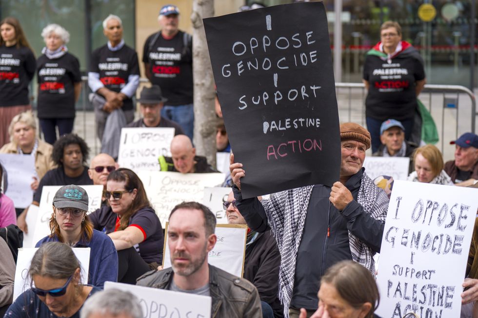 \u200bSeveral protesters held up signs reading 'I oppose genocide - I support Palestine Action'