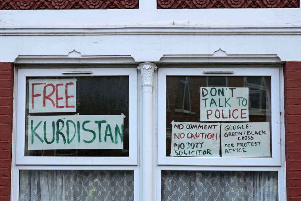 \u200bSigns are displayed on a window following a counter terrorism investigation