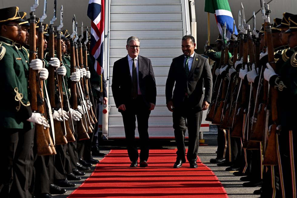 \u200bSir Keir Starmer is welcomed by a South African official as he arrives in the nation for the G20 summit
