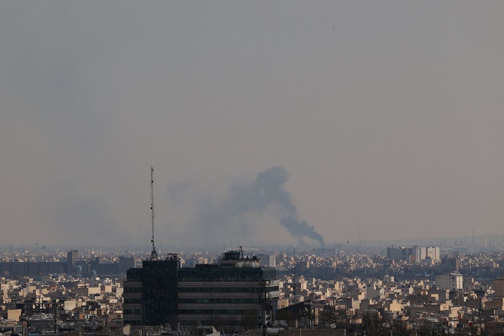 \u200bSmoke rises following a strike in Tehran