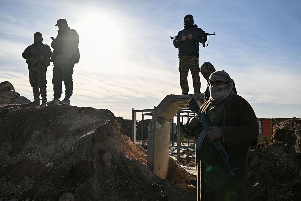 \u200bSoldiers of Syrian government forces stand by on a position 10 km away from the city of Hasakah in northeastern Syria