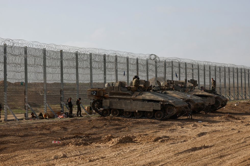 \u200bSoldiers sit on top of APC's, at the Israel-Gaza border, in Israel