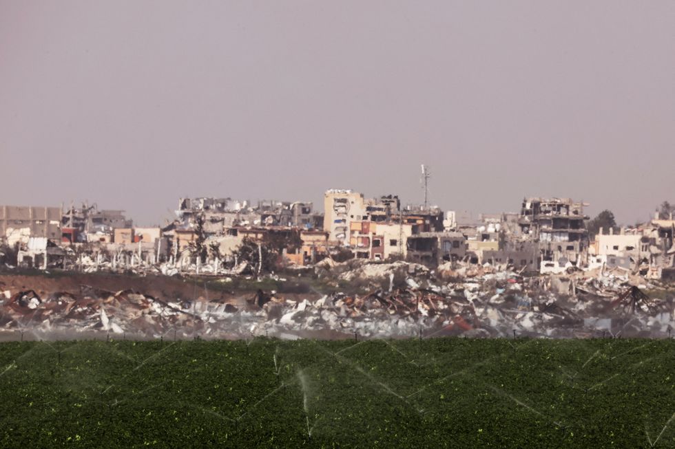 \u200bSprinklers water a field on the Israeli side of the Israel Gaza border, as seen from southern Israe