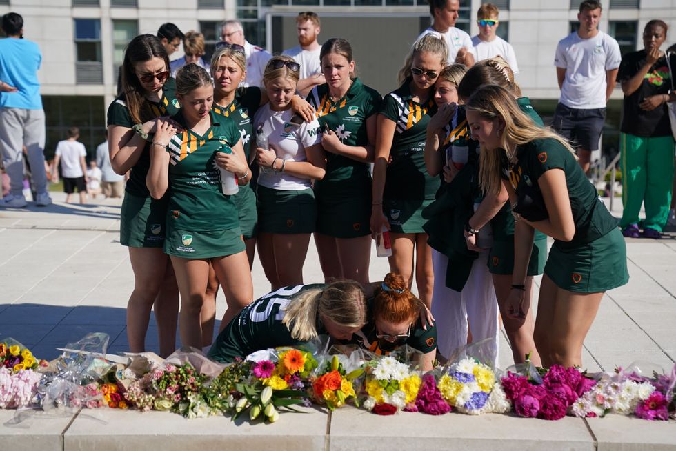 \u200bTeam mates of victim Grace O'Malley Kumar lay flowers in her memory during a vigil at the University of Nottingham