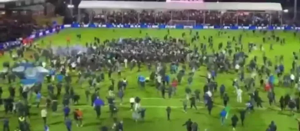 \u200bTelevision footage showed the 23-year-old goalkeeper falling to the turf and lying on the pitch as fans raced past him
