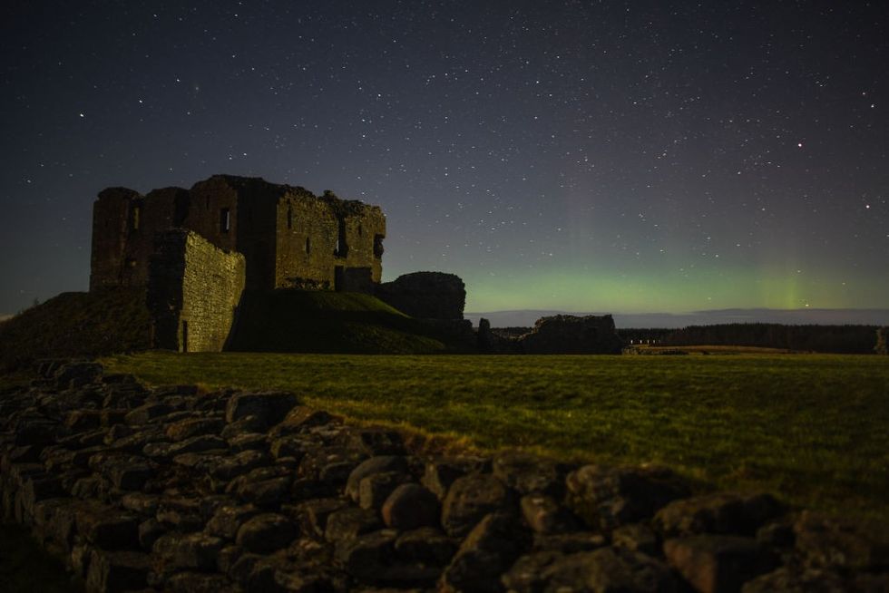 \u200bThe Aurora Borealis is seen above the ruins of Duffus Castle on February 20, 2021 in Duffus, Scotland.