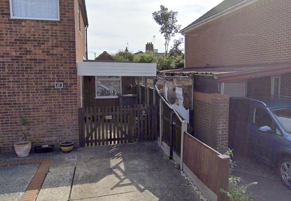 \u200bThe entrance to the alleyway with the boarded up door visible