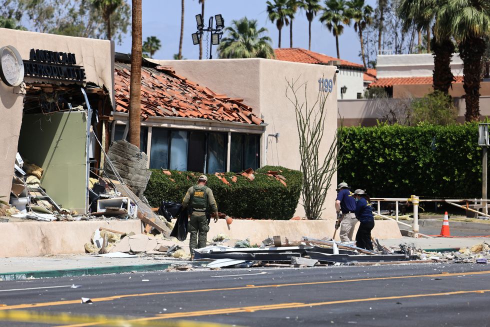 \u200bThe FBI and other law enforcement personnel gather evidence a day after a bomb exploded near a reproductive health facility