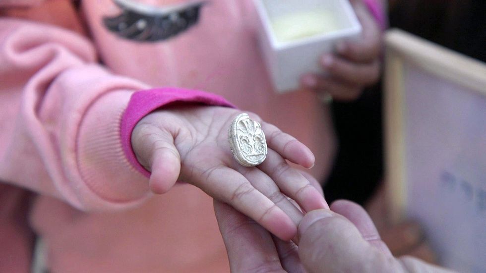 \u200bThe seal in the hand of 3.5-year-old Ziv.