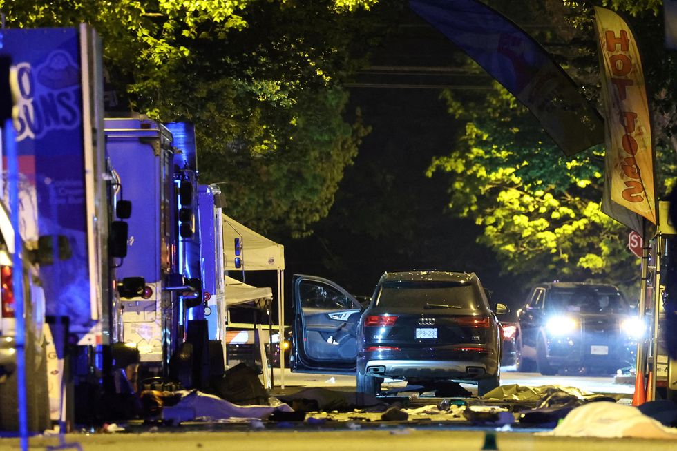 \u200bThe suspect vehicle is seen with the driver's door open, as bodies of victims lie covered on the ground, aft