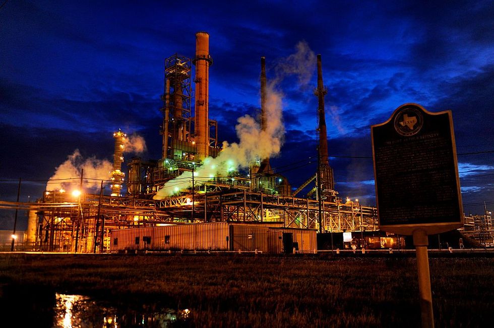 \u200bThe Valero refinery works glow in the dusk light in Port Arthur, Texas
