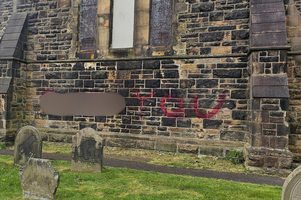 \u200bThe words 'f*** you' daubed on the side of the church