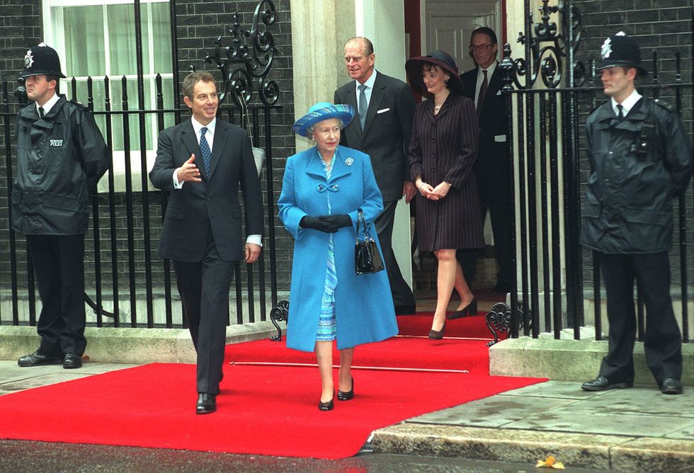 \u200bTony Blair escorts the Queen followed by the Duke of Edinburgh in 1997