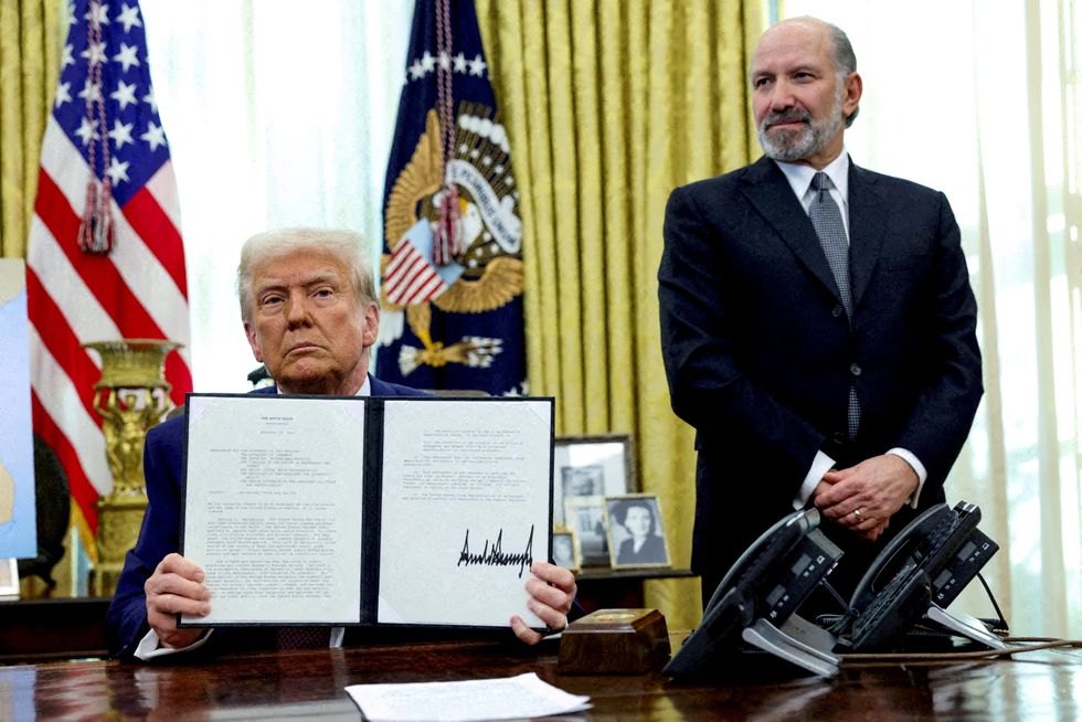 u200bTrump holds an executive order about tariffs increase, flanked by U.S. Commerce Secretary Howard Lutnick