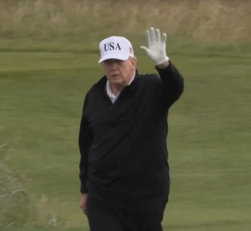 \u200bTrump seen waving to members of the press on the course