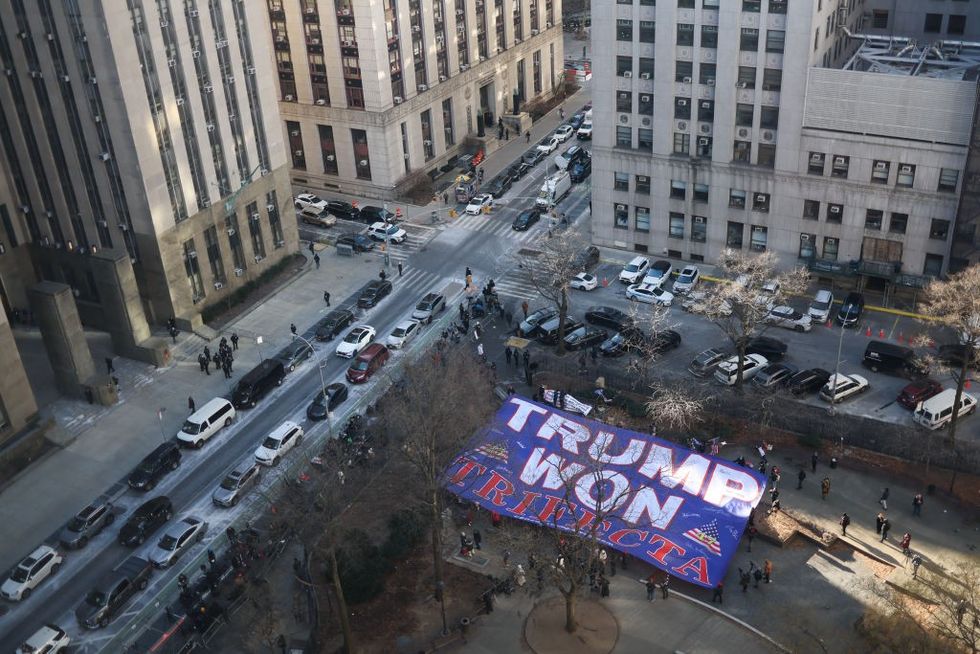 \u200bTrump supporters display a giant flag outside the Manhattan Criminal Court in New York,