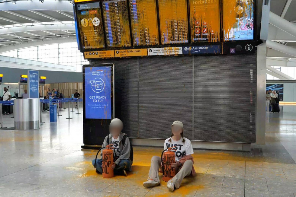 \u200bTwo protesters sat in the terminal building