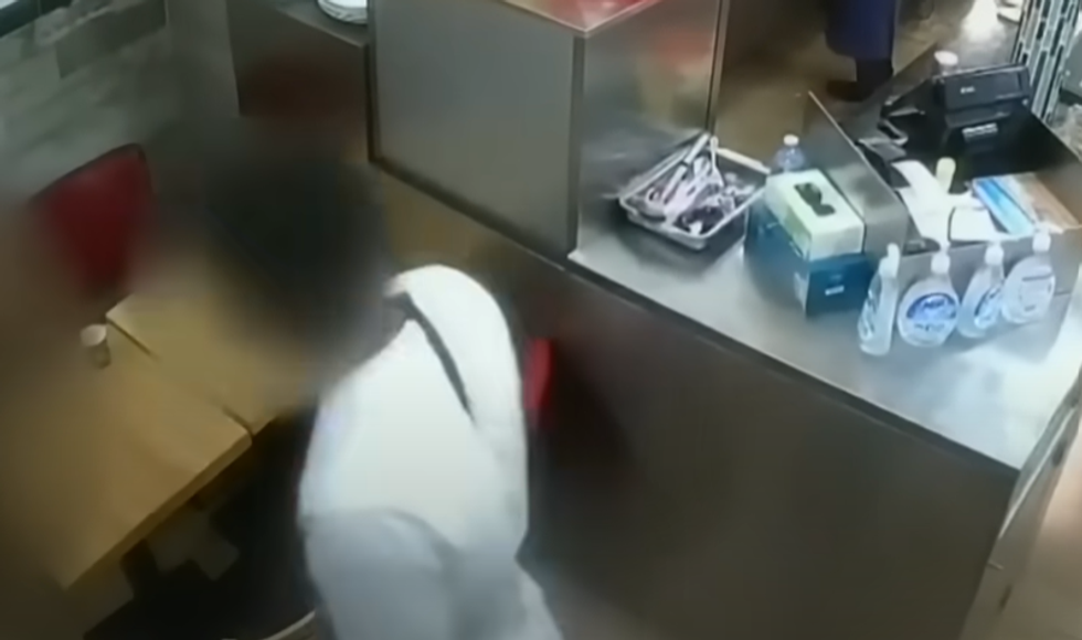 \u200bUpon entering the shop, the man went over to the woman and tapped her on the shoulder