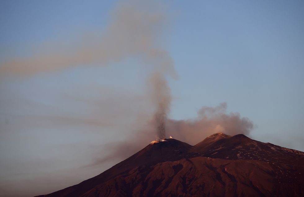 \u200bVolcanic steam rises at sunrise from Mount Etna, near Motta Camastra, Sicily, Italy