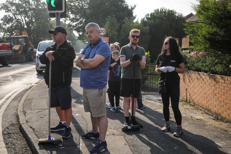 \u200bVolunteers sweep Sussex Road in Southport, Merseyside