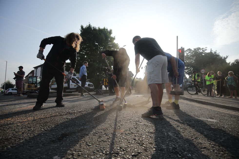 \u200bVolunteers sweep Sussex Road in Southport, Merseyside