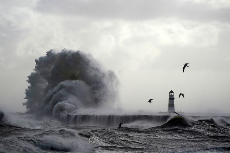 \u200bWaves crash against the lighthouse in Seaham Harbour, County Durham
