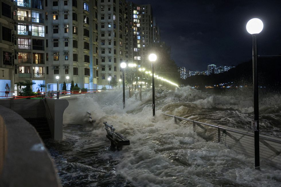 \u200bWaves pour into the seafront onto flood barriers