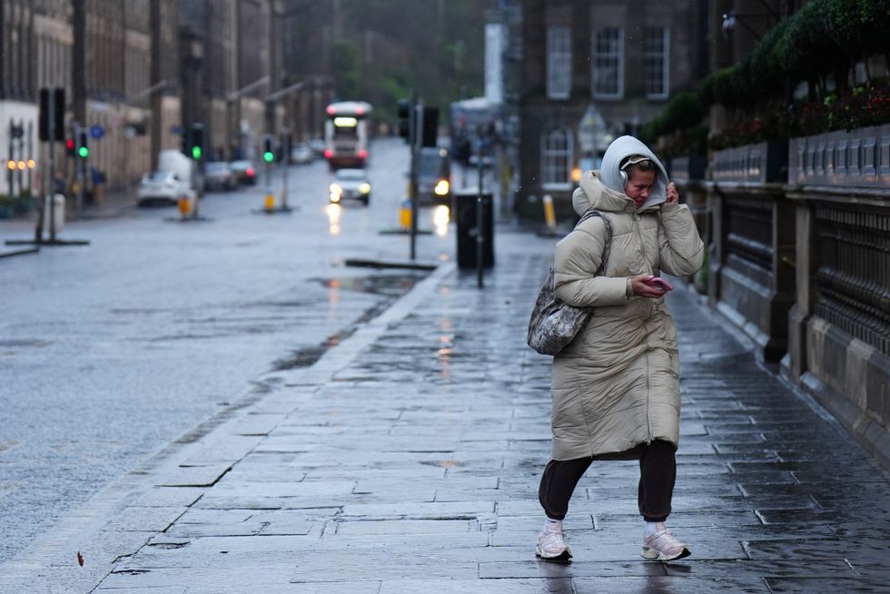 \u200bWoman buffeted by strong winds