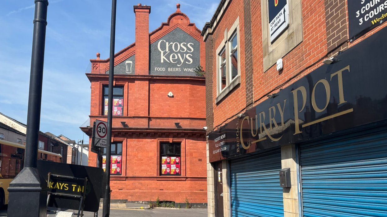 \u201cVote Andy\u201d posters placed in the windows of a derelict pub in Ashton-in-Makerfield
