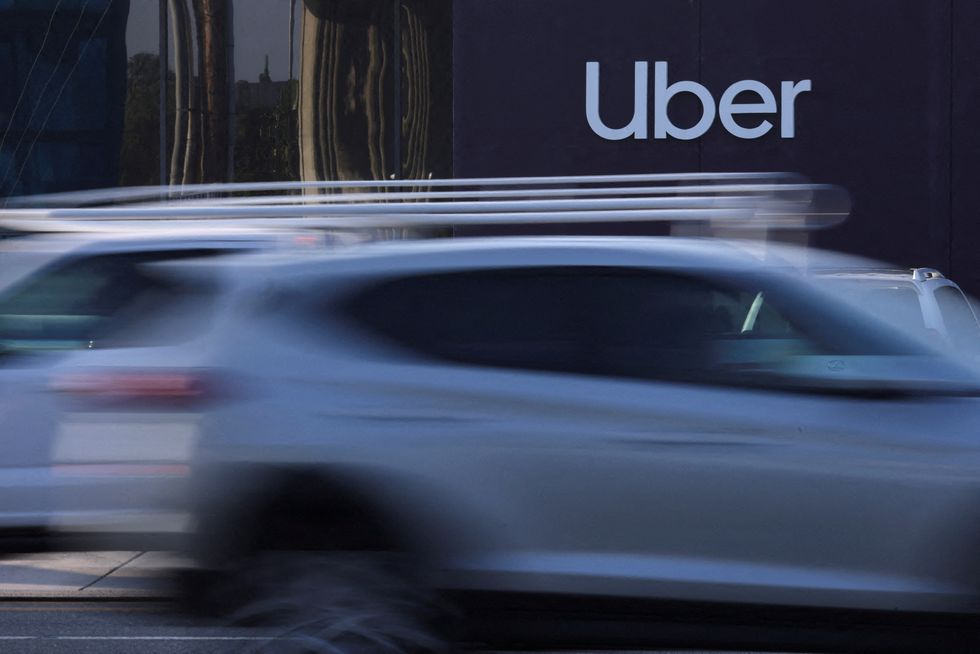 Uber logo with cars driving in front