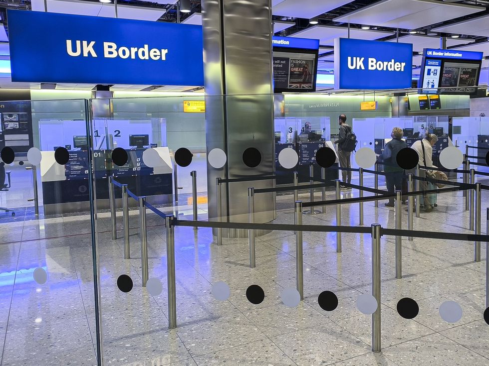 UK Border sign is seen at the arrivals passport control and visa area of London Heathrow Airport LHR