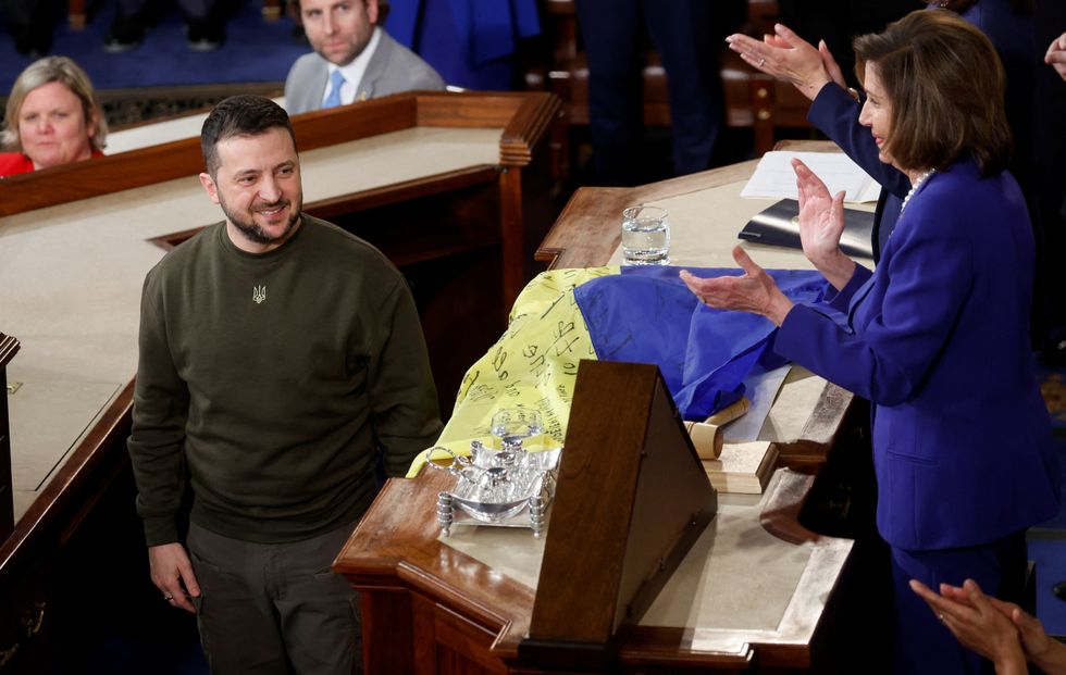 Ukraine's President Volodymyr Zelenskiy looks on as U.S. House Speaker Nancy Pelosi (D-CA) applauds, during a joint meeting of U.S. Congress in the House Chamber of the U.S. Capitol in Washington, U.S., December 21, 2022. REUTERS/Jonathan Ernst