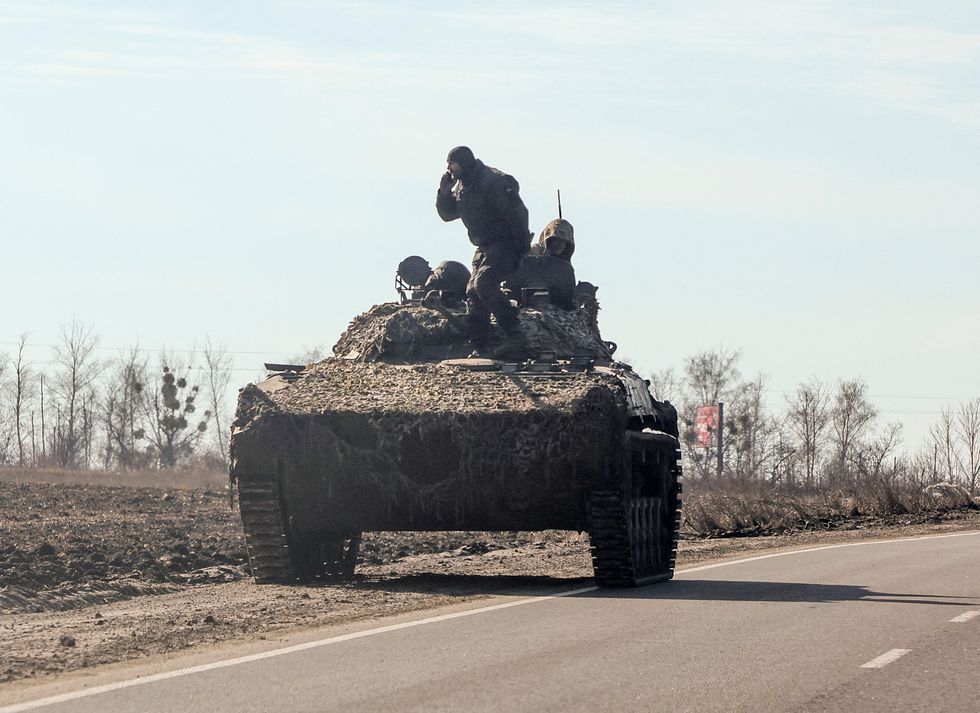 Ukrainian army soldier are seen on an armoured vehicle, after Russian President Vladimir Putin authorised a military operation, in eastern Ukraine, in Kharkiv region, Ukraine February 24, 2022. REUTERS/Antonio Bronic