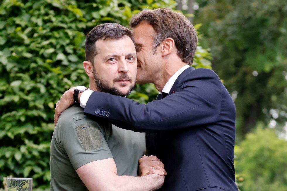 Ukrainian President Volodymyr Zelenskiy and French President Emmanuel Macron embrace after giving a news conference, as Macron, German Chancellor Olaf Scholz and Italian Prime Minister Mario Draghi visit Kyiv, Ukraine June 16, 2022. Ludovic Marin/Pool via REUTERS