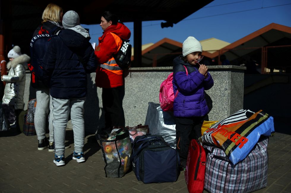 Ukrainian refugees wait on the platform after arriving from Odesa after fleeing the Russian invasion of Ukraine