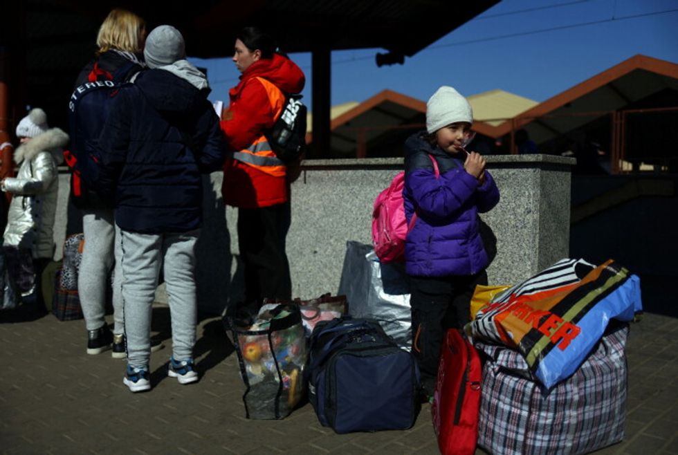 Ukrainian refugees wait on the platform after arriving from Odesa after fleeing the Russian invasion of Ukraine