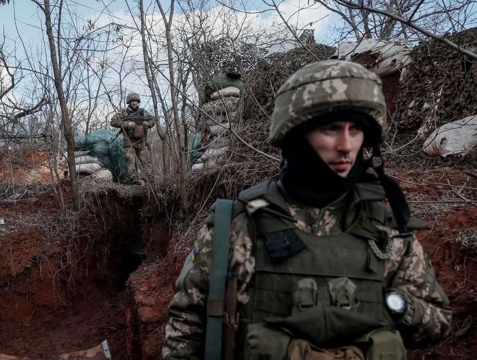 Ukrainian service members are seen on the front line near the city of Novoluhanske in the Donetsk region, Ukraine February 20, 2022. REUTERS/Gleb Garanich