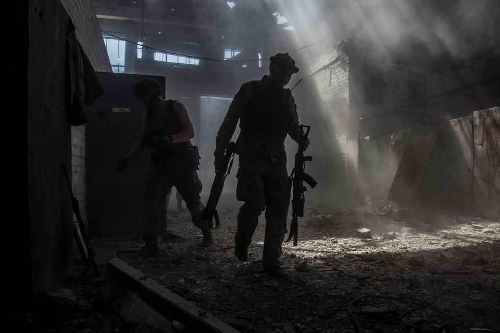 Ukrainian service members walk in the industrial area of the city of Sievierodonetsk, as Russia's attack on Ukraine continues, Ukraine June 20, 2022. Picture taken June 20, 2022. REUTERS/Oleksandr Ratushniak