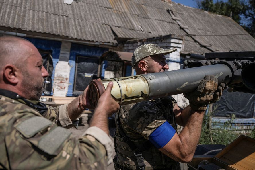 Ukrainian servicemen of the 108th Separate Brigade of Territorial Defence load a shell into a small multiple launch rocket systems before firing toward Russian troops