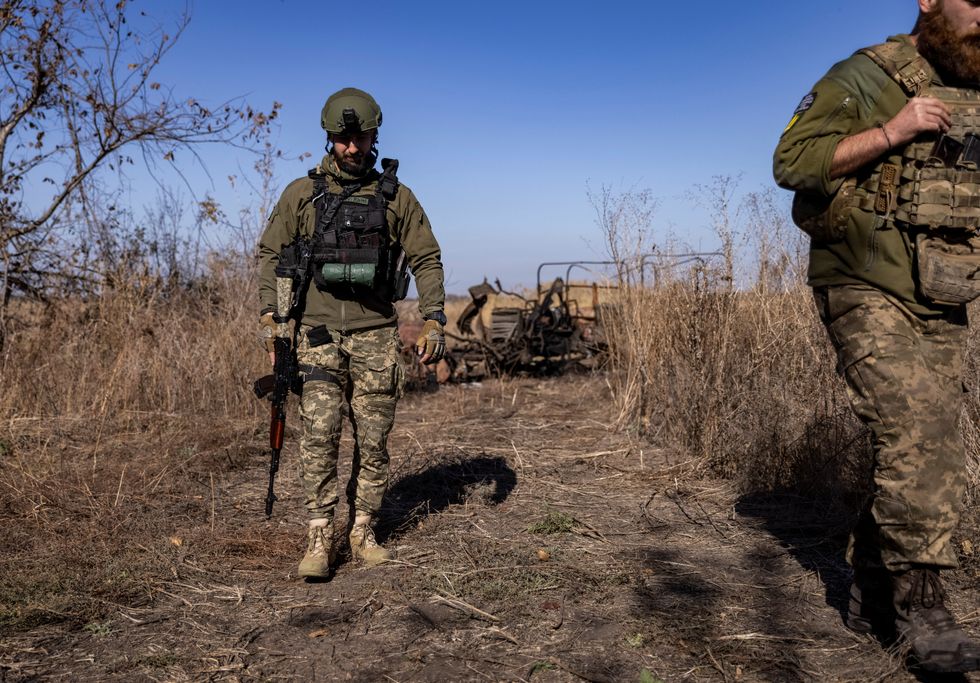 Ukrainian servicemen walk at a position near a frontline, amid Russia's attack on Ukraine, in Donetsk region