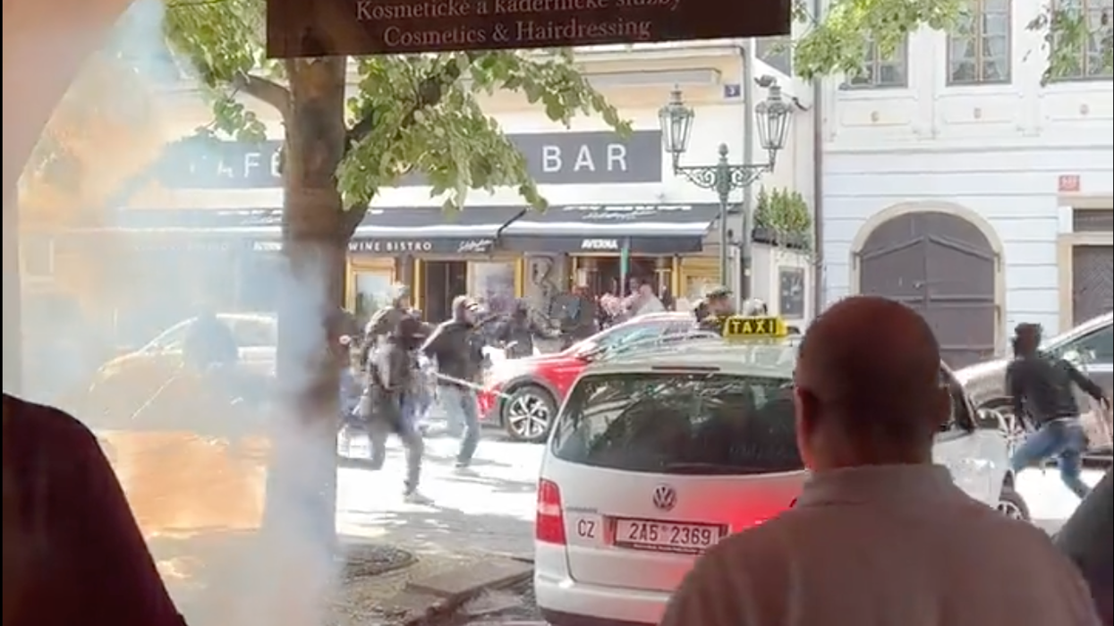 Ultras are seen rushing away from the scene