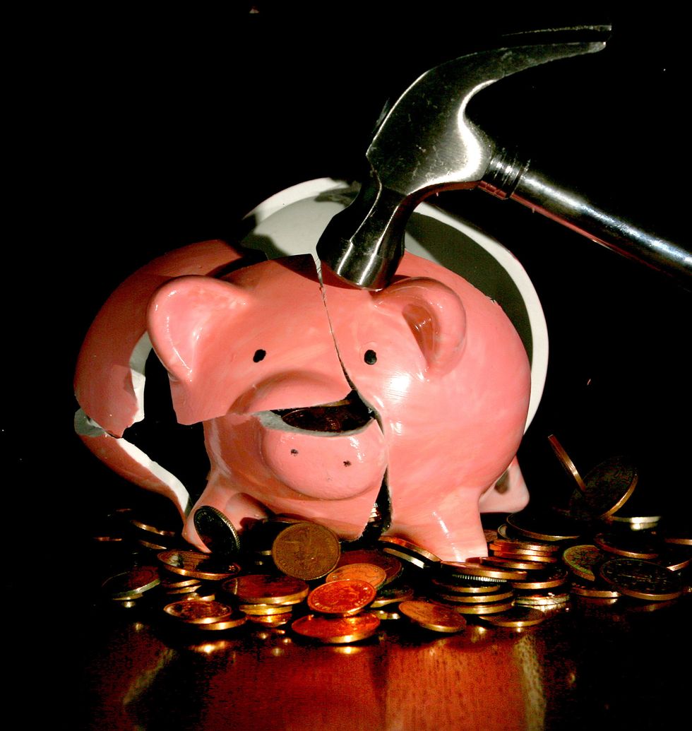 Undated file photo of a traditional piggy bank being smashed open. Cost-of-living concerns could drive some pension savers into scammers' clutches, research from the City regulator suggests. A quarter (25 percent) of people said they would consider withdrawing their pension savings earlier than planned to cover living costs, potentially making them vulnerable to criminals. Issue date: Thursday October 6, 2022.