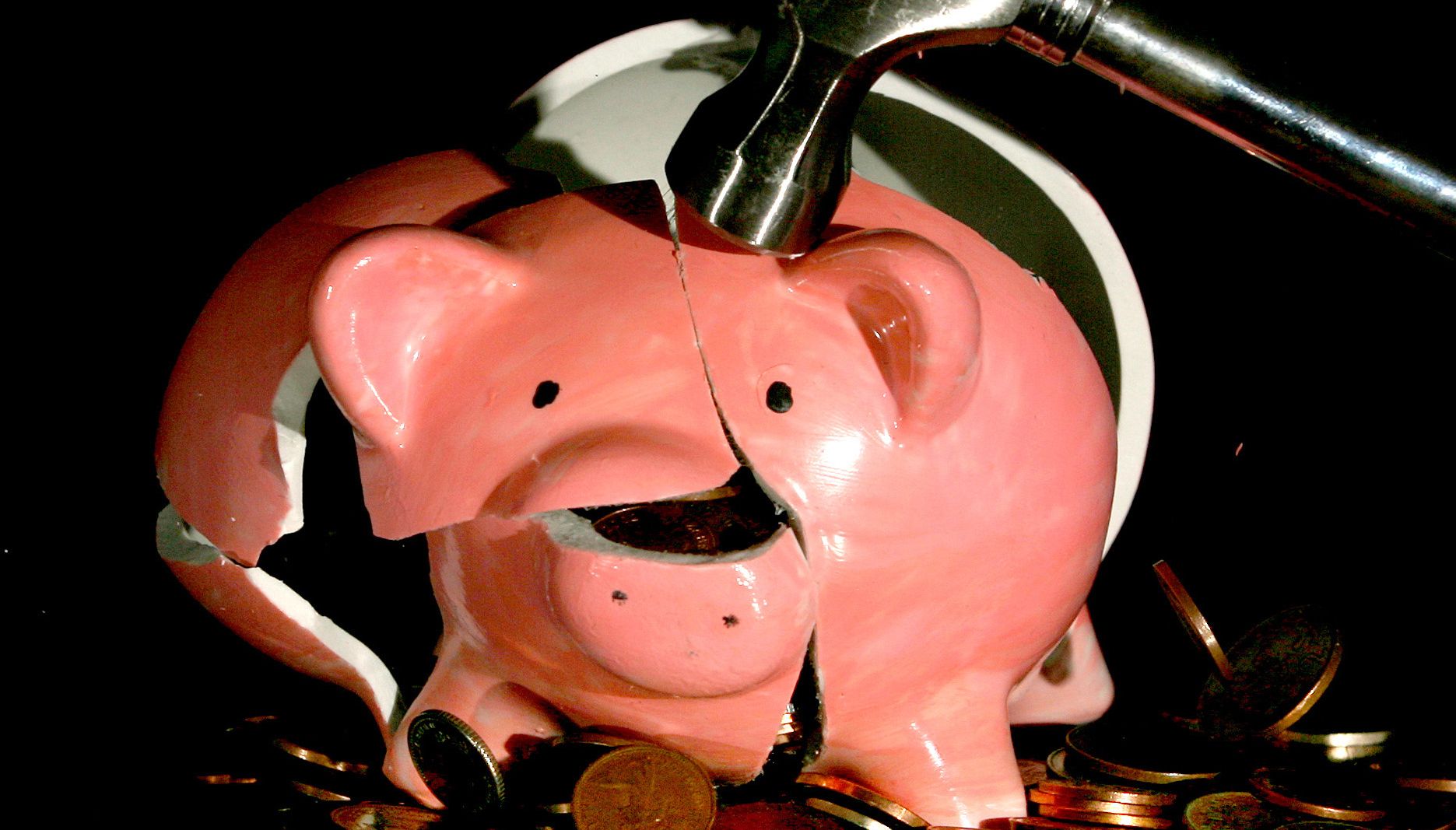 Undated file photo of a traditional piggy bank being smashed open. Cost-of-living concerns could drive some pension savers into scammers' clutches, research from the City regulator suggests. A quarter (25 percent) of people said they would consider withdrawing their pension savings earlier than planned to cover living costs, potentially making them vulnerable to criminals. Issue date: Thursday October 6, 2022.