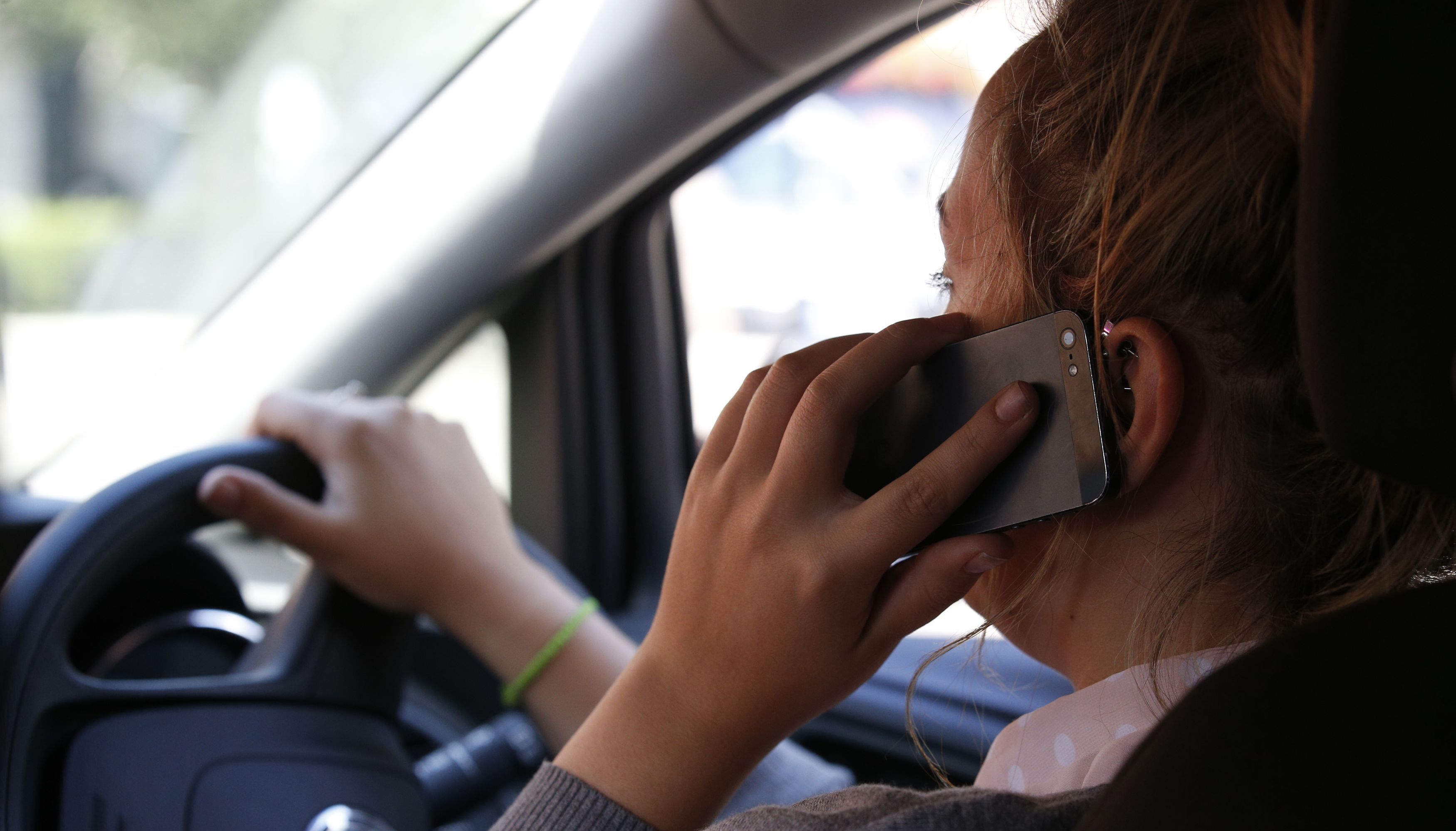 Undated file photo of a woman talking on her phone whilst driving. A loophole allowing drivers to escape punishment for hand-held phone use if they are taking a photo or playing a game will be closed from Friday. Issue date: Friday March 25, 2022.